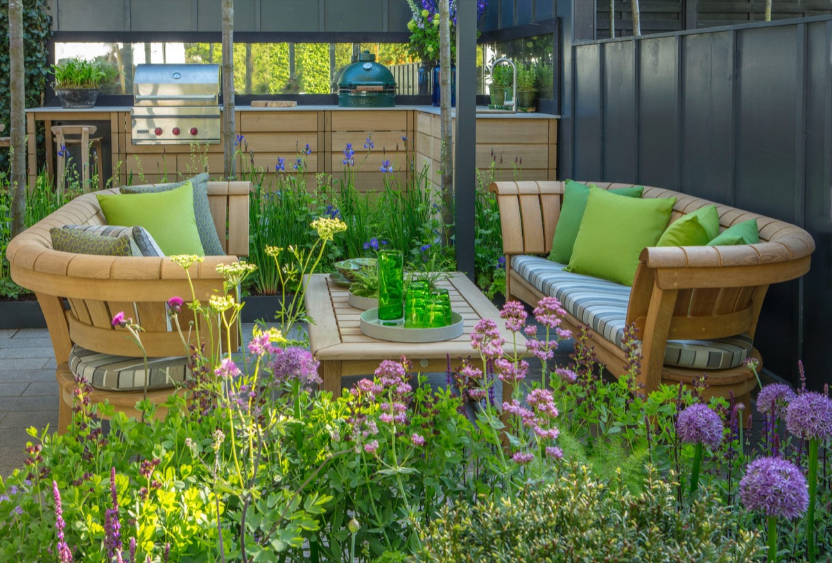Gaze Burvill oak seating around a low table, alliums and cow parsley in front